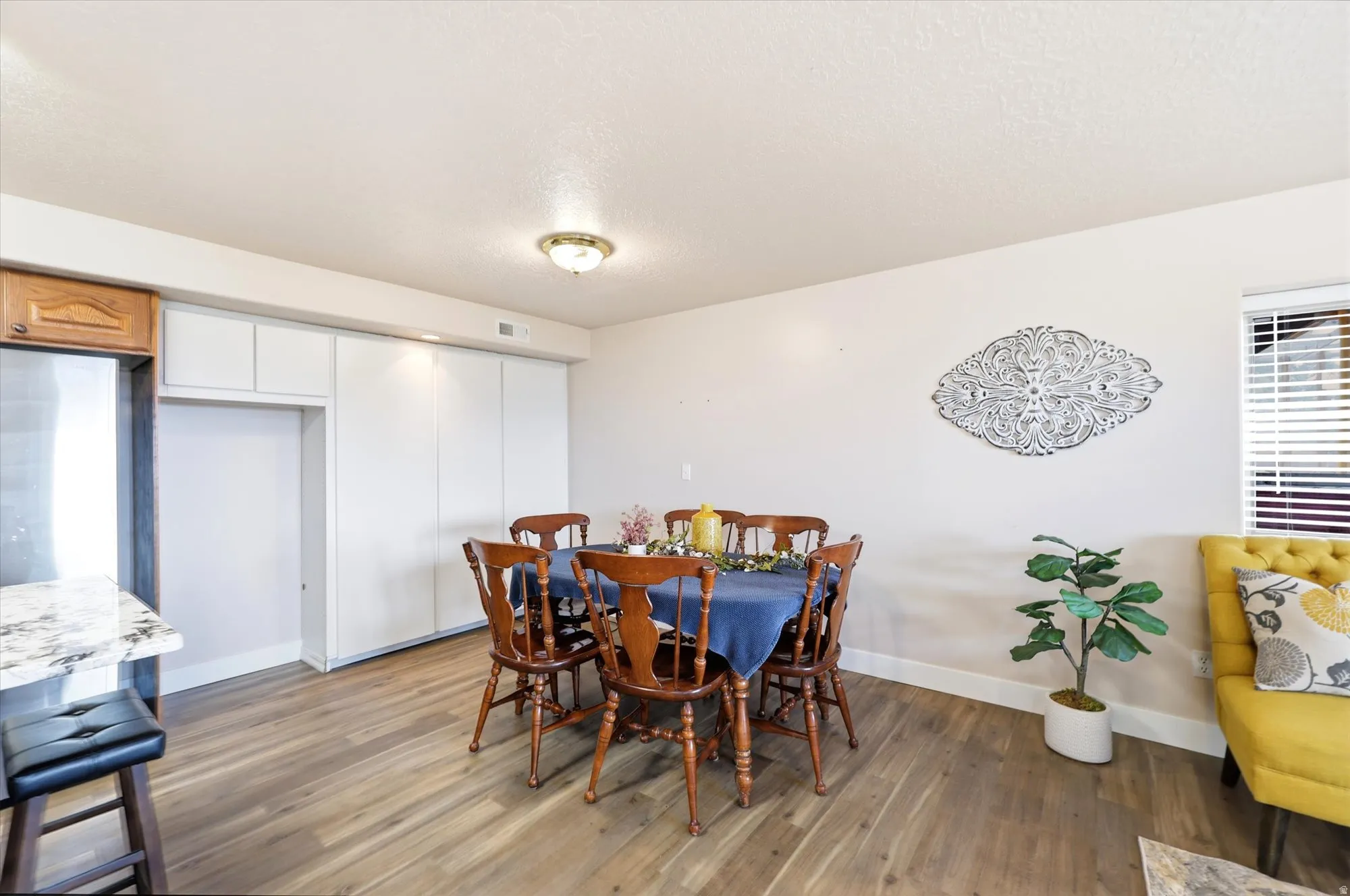 Dining area featuring a built-in pantry and a baker's shelf or freezer enclosure