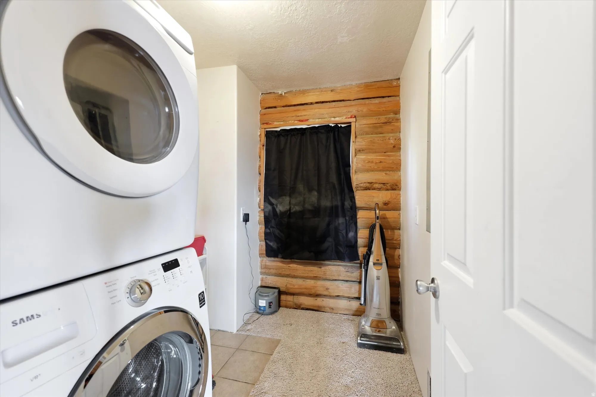 Laundry area featuring a stacked washer and dryer
