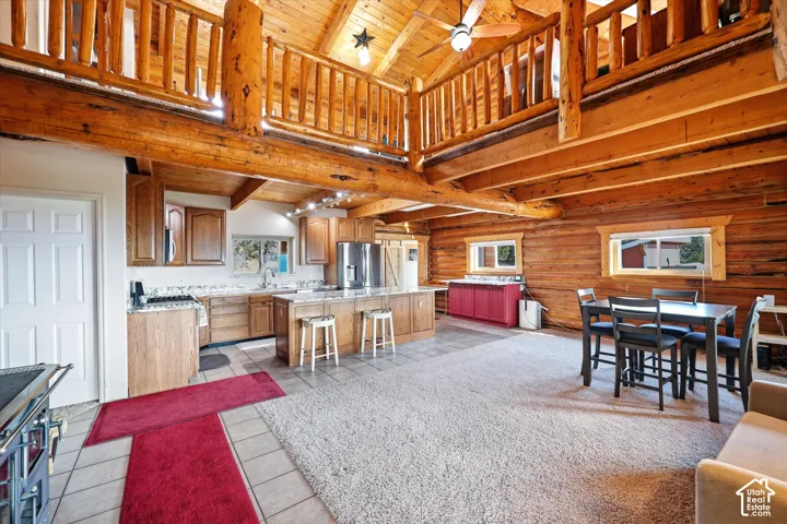 loft with wood railing white door leads to laundry/utility room