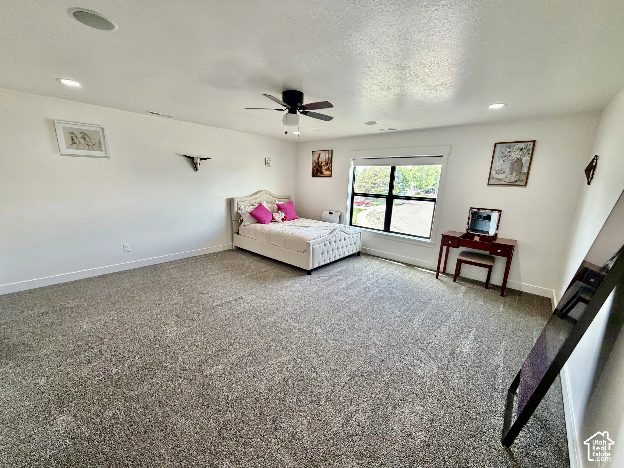 Spacious room with gray carpet flooring and white walls