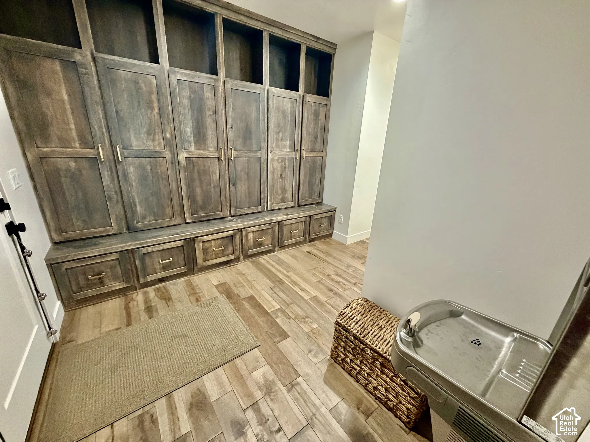 Built-in wooden cabinetry featuring multiple storage compartments, drawers, and open shelving