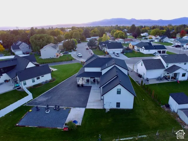 Expansive paved driveway, attached two-car garage, covered porch, and a gravel outdoor area
