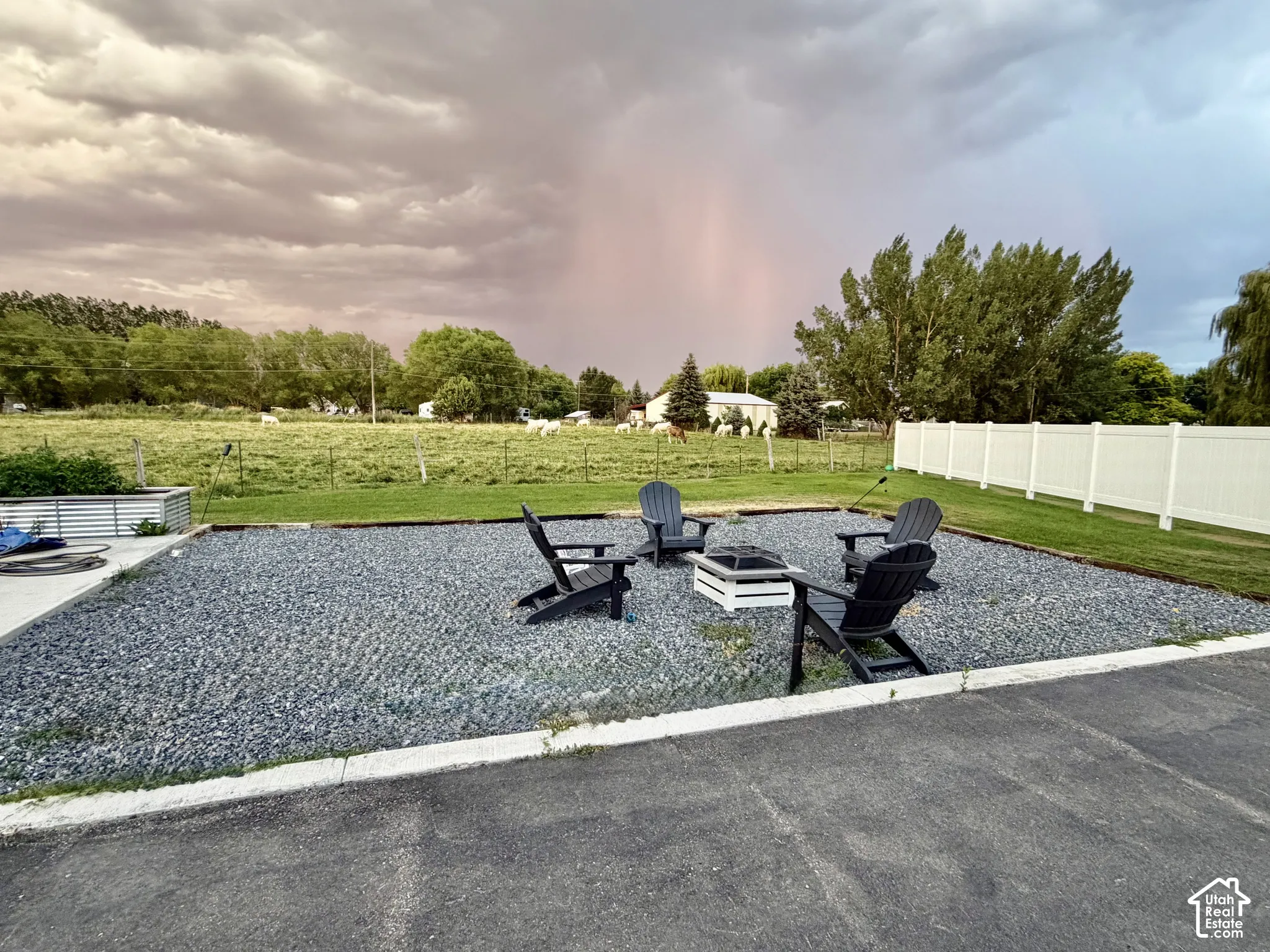 Gravel patio area featuring a fire pit