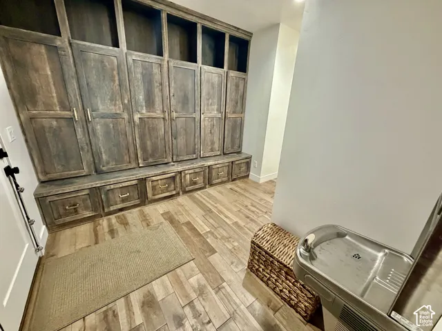 Built-in wooden cabinetry featuring multiple storage compartments, drawers, and open shelving