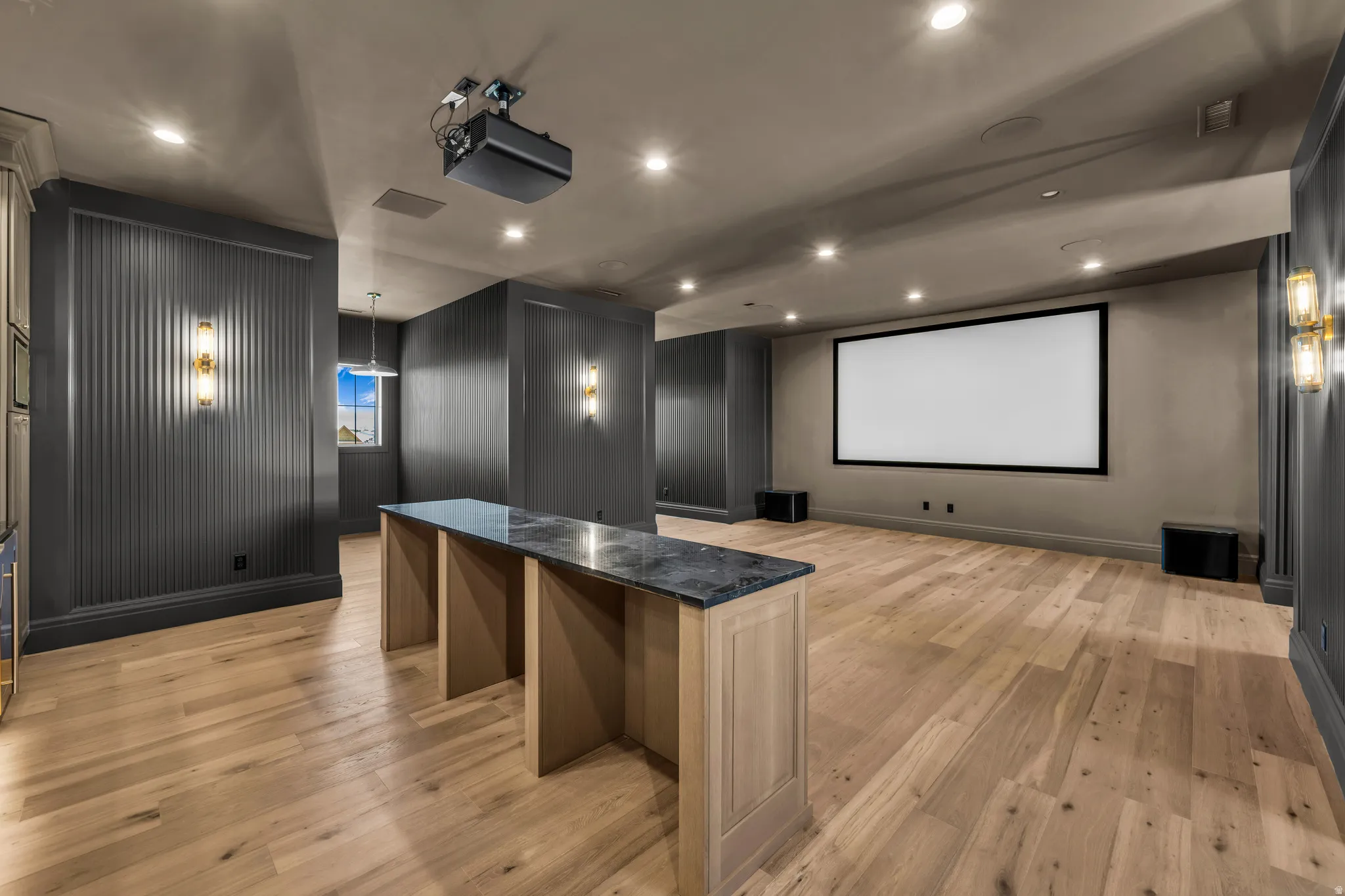 Dedicated media room featuring a large projection screen and ceiling-mounted projector