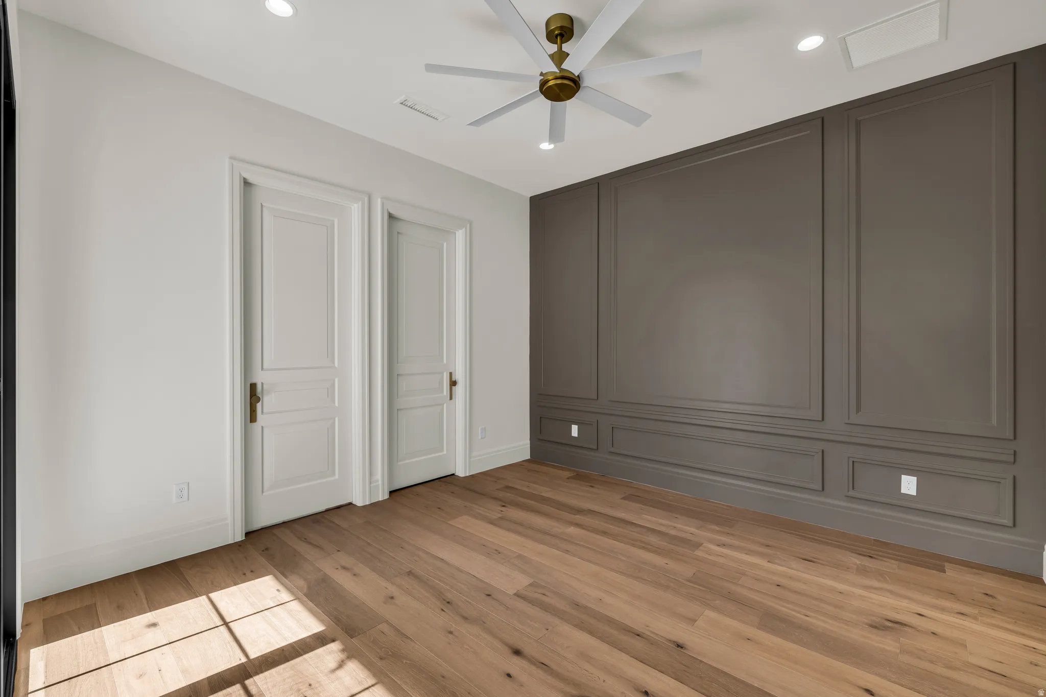 Wood-finish flooring with a multi-tone panel accent wall