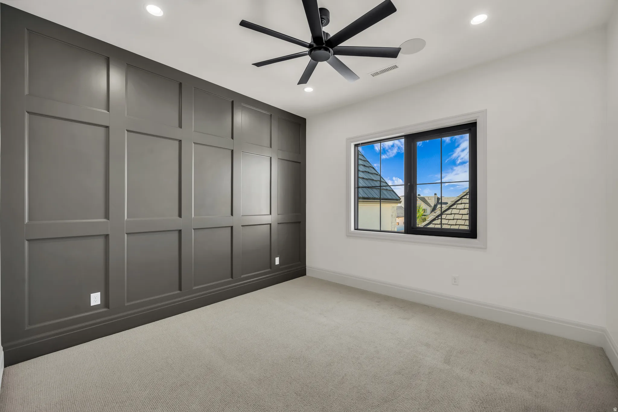 Accent wall featuring dark paneled wainscoting