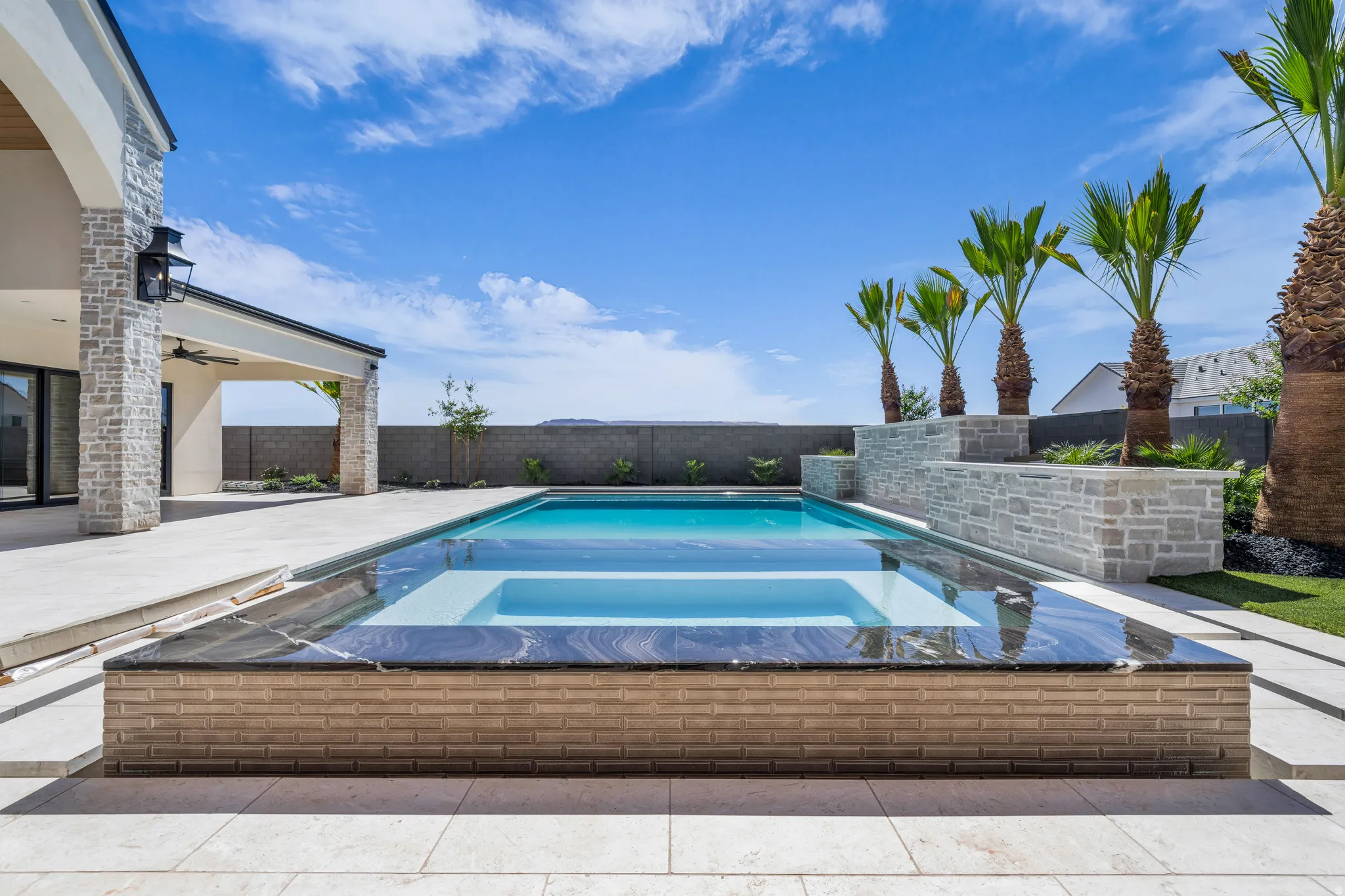 Contemporary backyard oasis featuring a rectangular swimming pool with an integrated spa