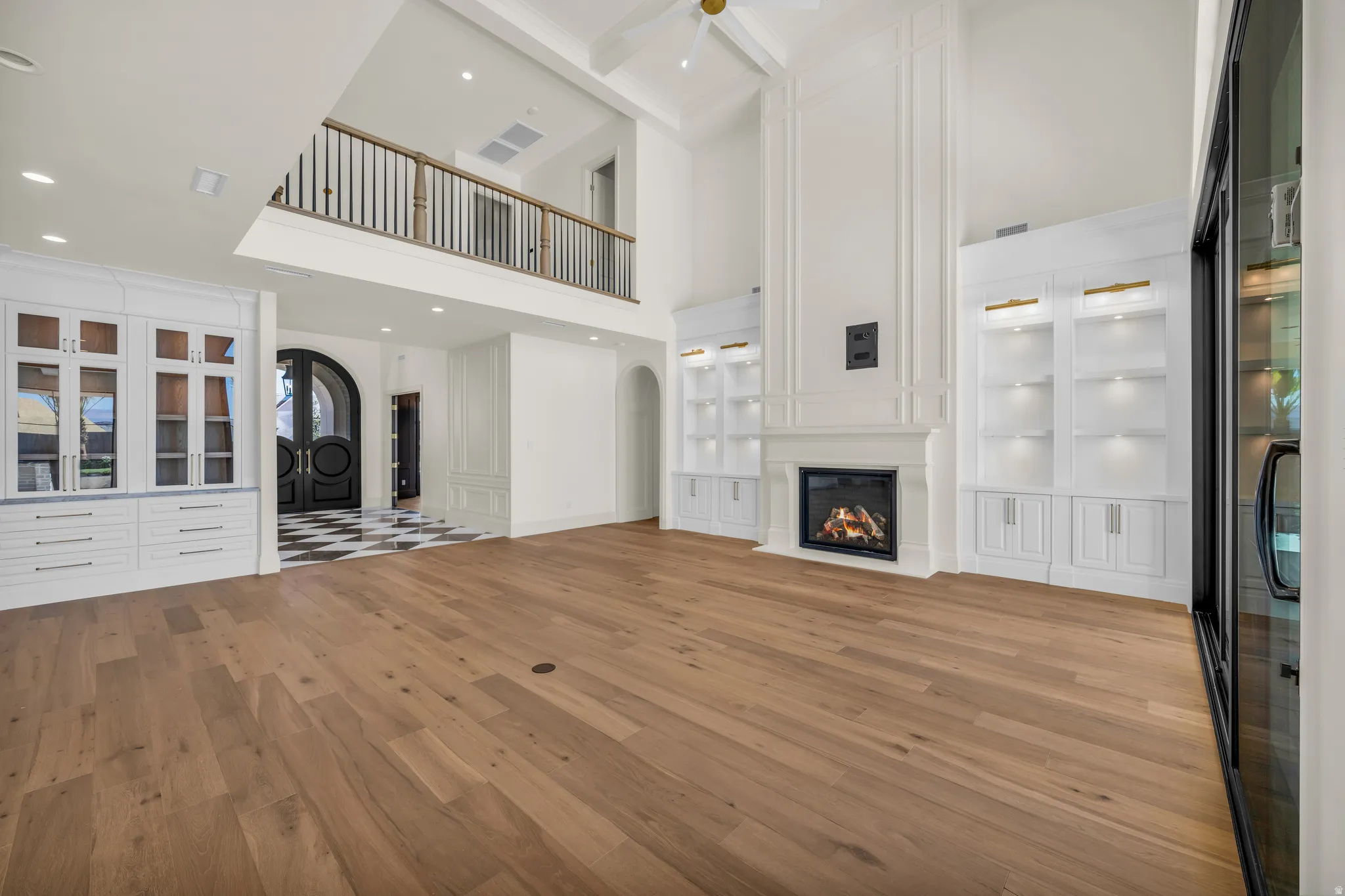 Spacious interior with wood-finish flooring and a double-height ceiling
