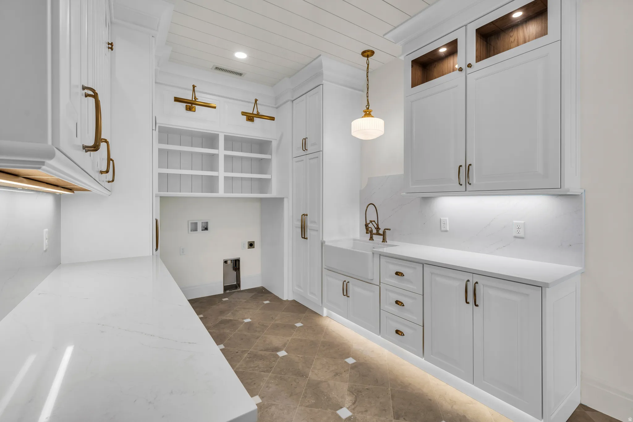 Utility room featuring white cabinetry, quartz countertops, a farmhouse sink, and under-cabinet lighting