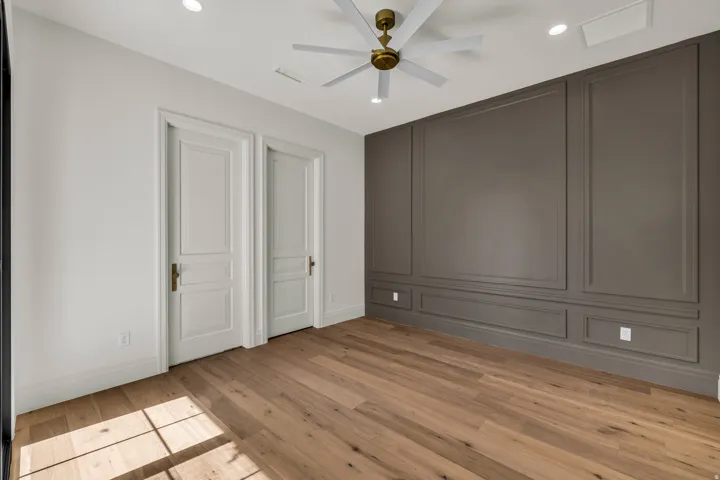Wood-finish flooring with a multi-tone panel accent wall