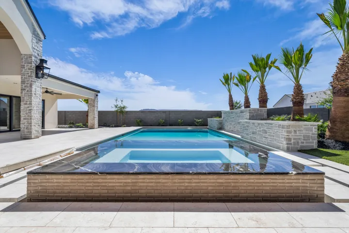 Contemporary backyard oasis featuring a rectangular swimming pool with an integrated spa
