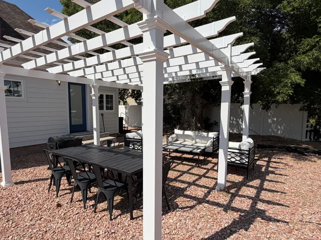 White pergola structure over a spacious outdoor area