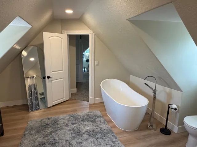 Freestanding soaking tub with floor-mounted faucet