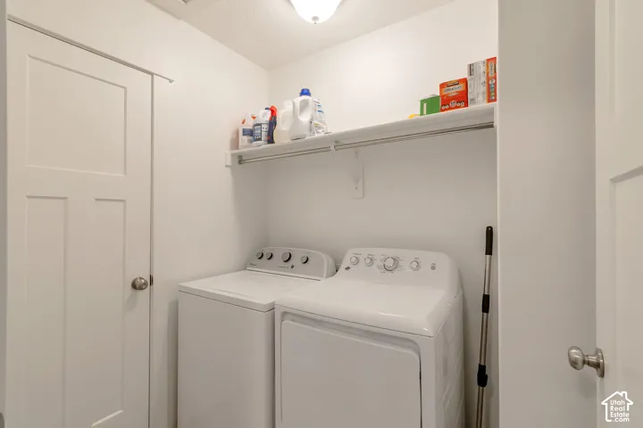 Dedicated laundry area featuring a shelf with hanging rod