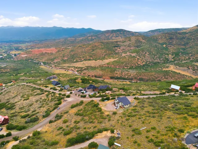Expansive mountain landscape featuring varied terrain and multiple residential structures