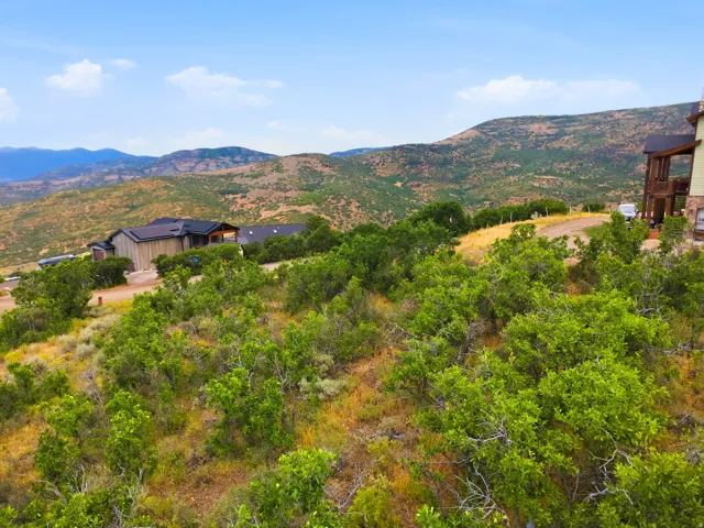 Expansive property with a backdrop of rolling hills and distant mountains