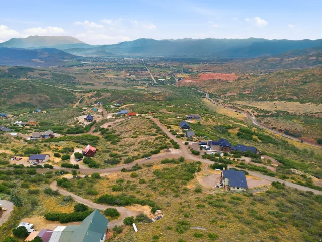 Expansive natural landscape featuring rolling hills and distant mountains