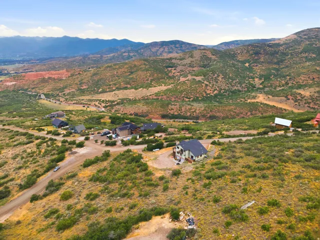 Expansive mountain landscape featuring a dispersed residential community