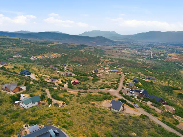 Expansive hillside landscape featuring residential properties and winding roads