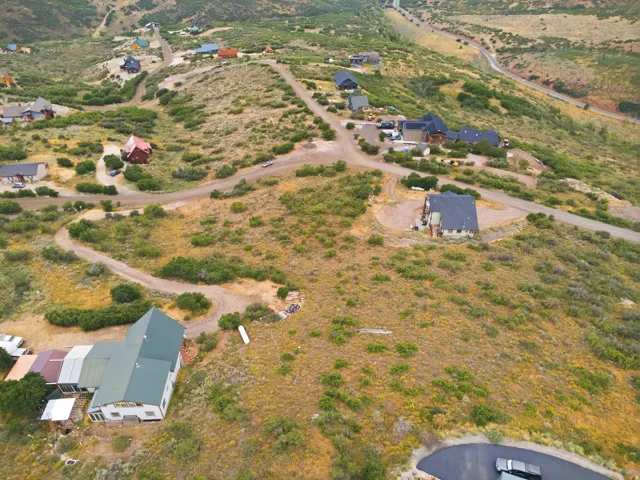 Expansive hillside property featuring multiple residences with varied architectural styles and an established road network