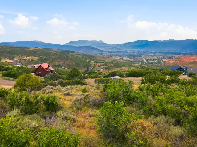 Expansive mountain landscape featuring varied terrain and distant valleys