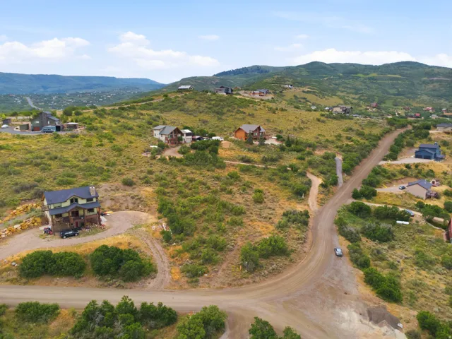 Expansive hillside properties with multiple residential structures, surrounded by natural vegetation