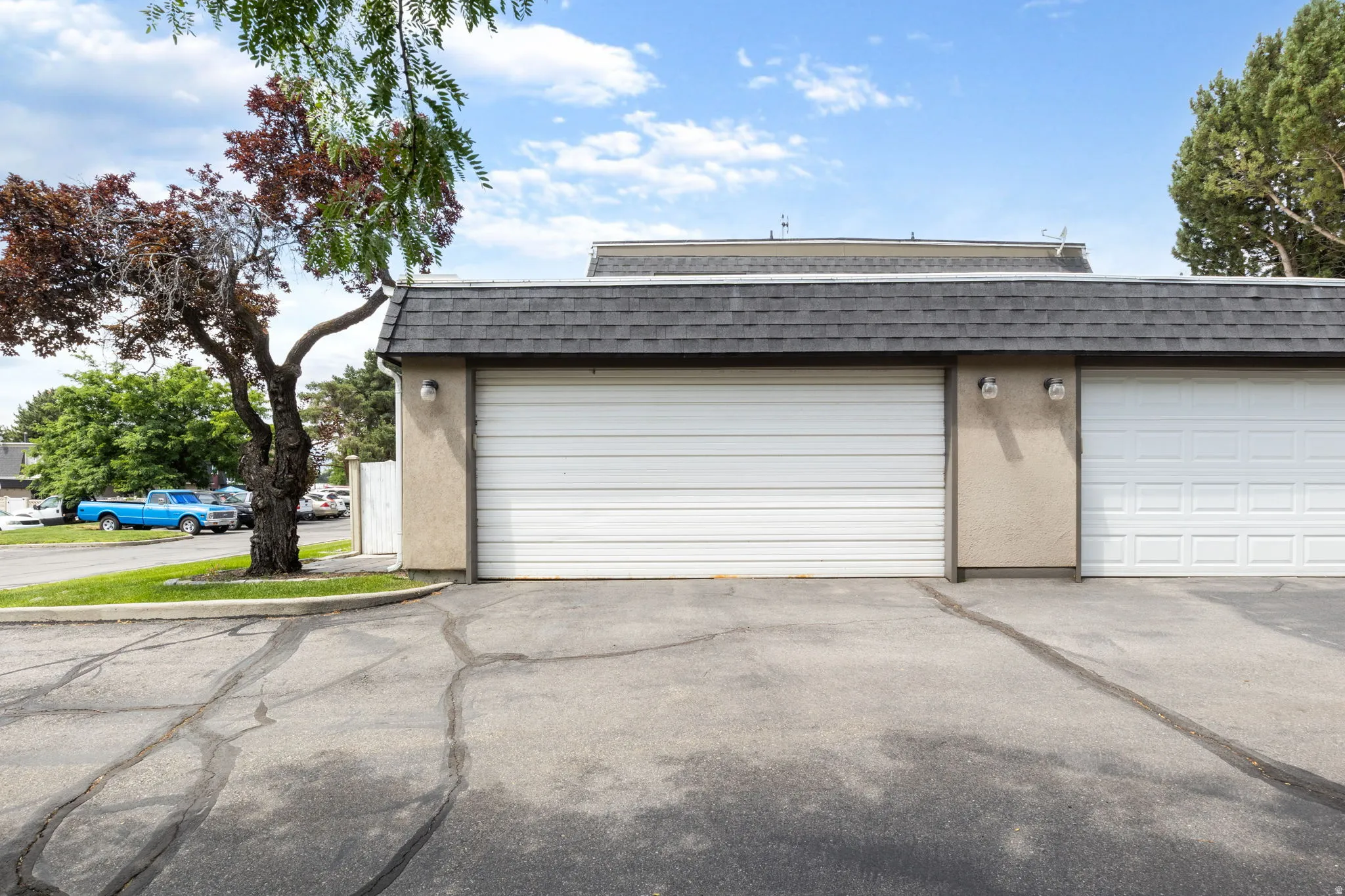Two separate garage doors with textured stucco exterior