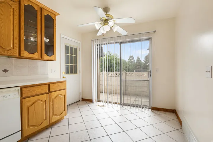 Kitchen area with tile flooring and light wood cabinetry