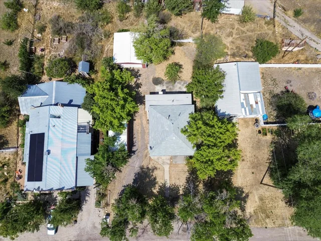 Aerial perspective showcasing multiple structures and mature trees
