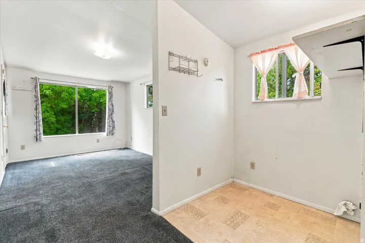 Carpeted interior space with a large window