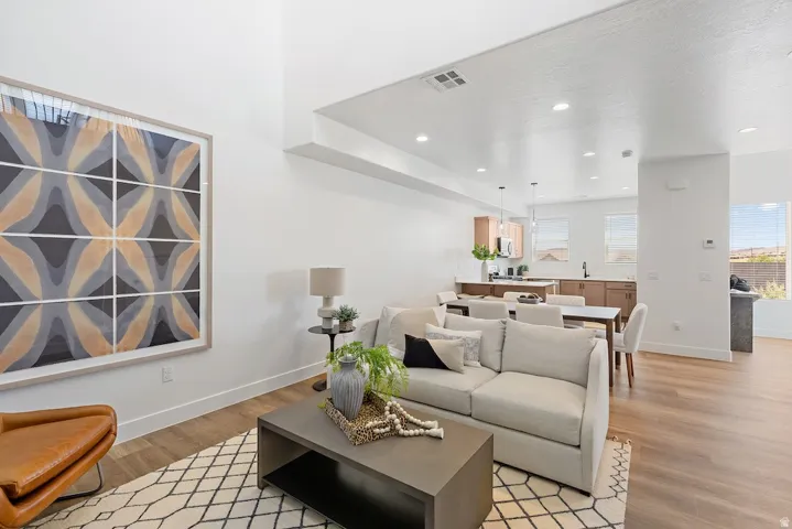 Open-concept living area with high ceilings and wood-finish flooring