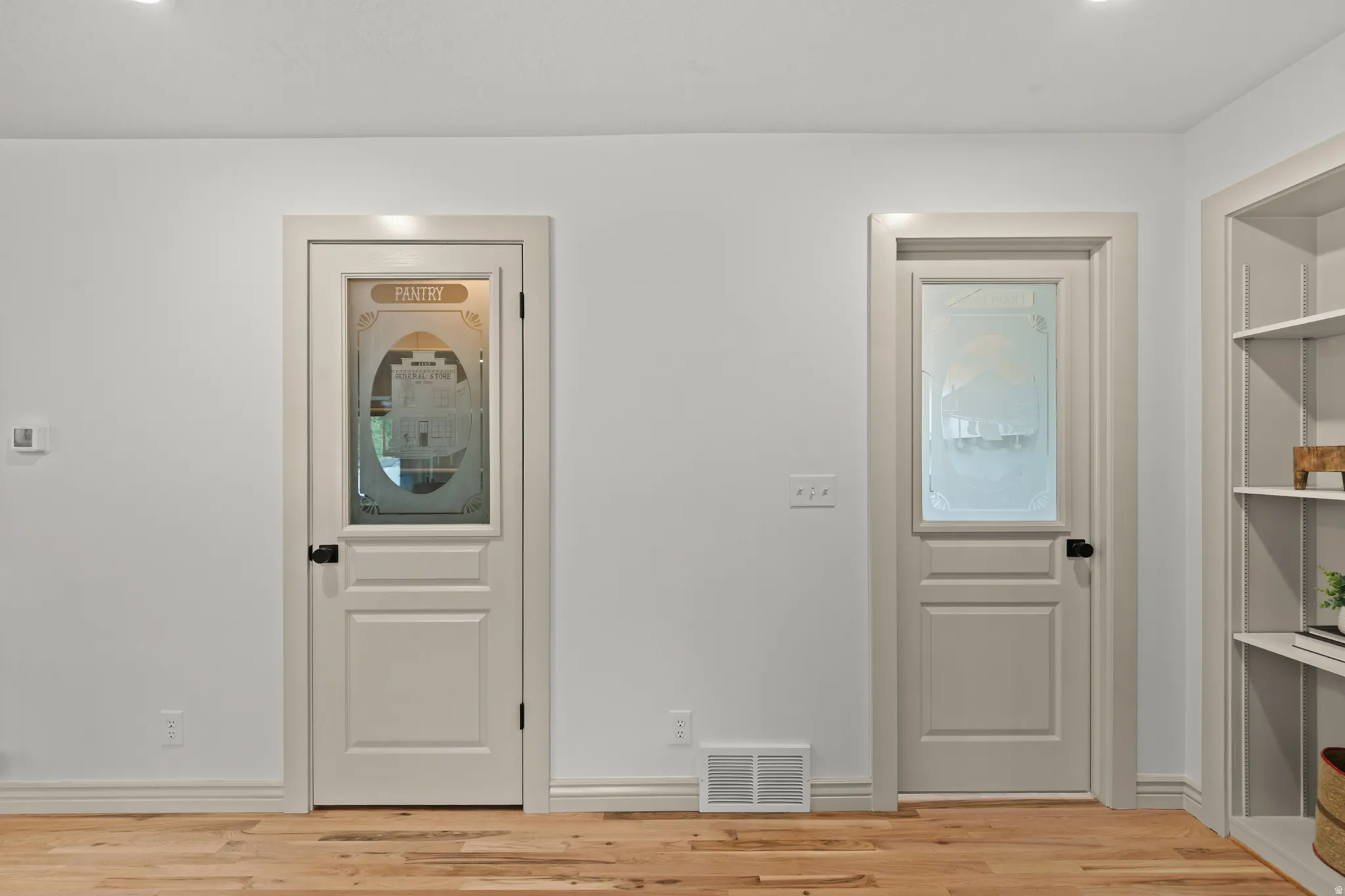 Light wood-finish flooring complements white walls with matching baseboards