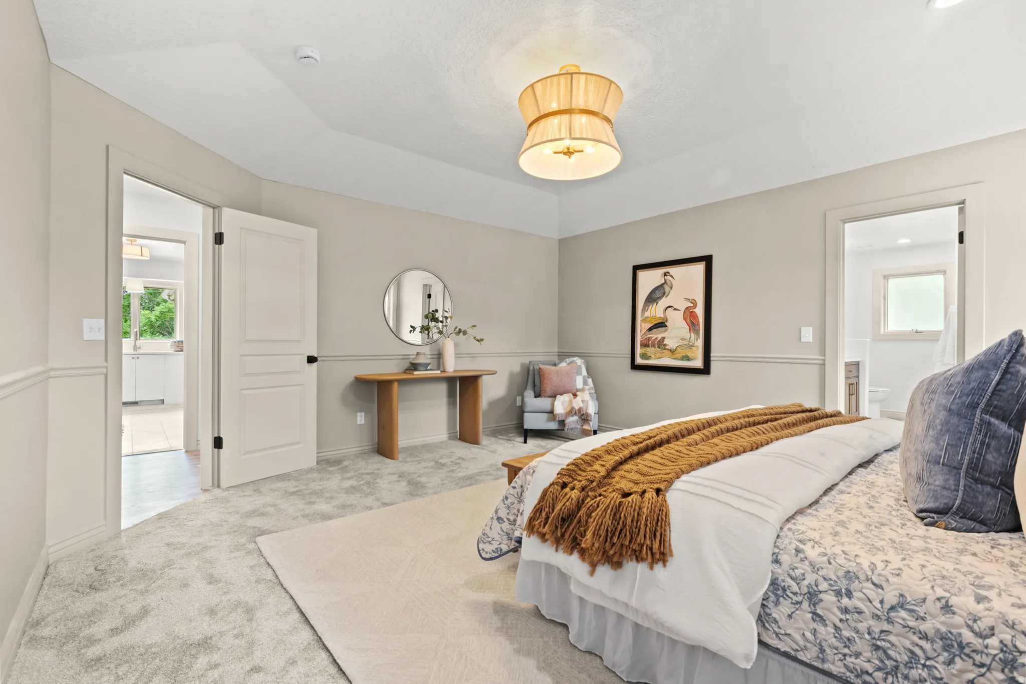 Light gray wall-to-wall carpeting complements neutral wall tones with wainscoting details