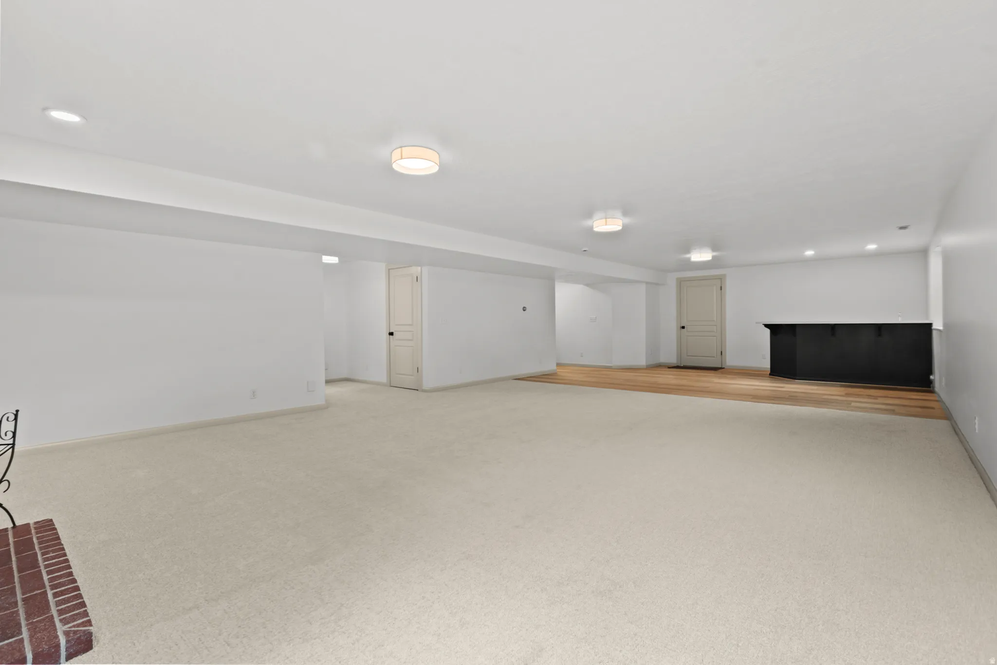 Spacious lower-level area with recessed lighting and flush-mount fixtures