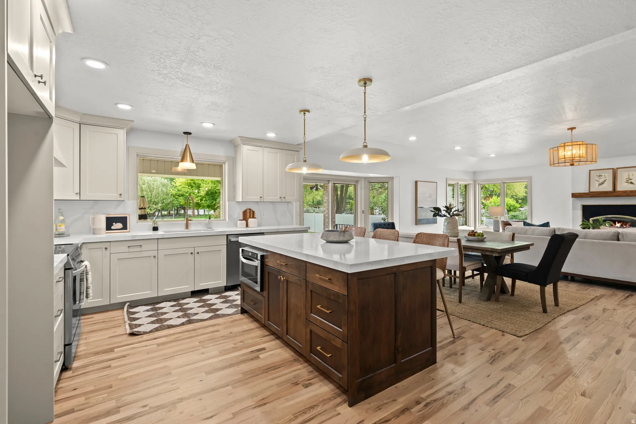 Open-concept kitchen and living area featuring a large, custom built walnut island.