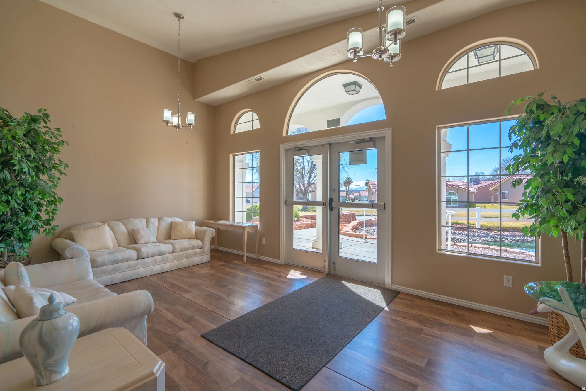 Entry foyer featuring high ceilings and wood-finish flooring
