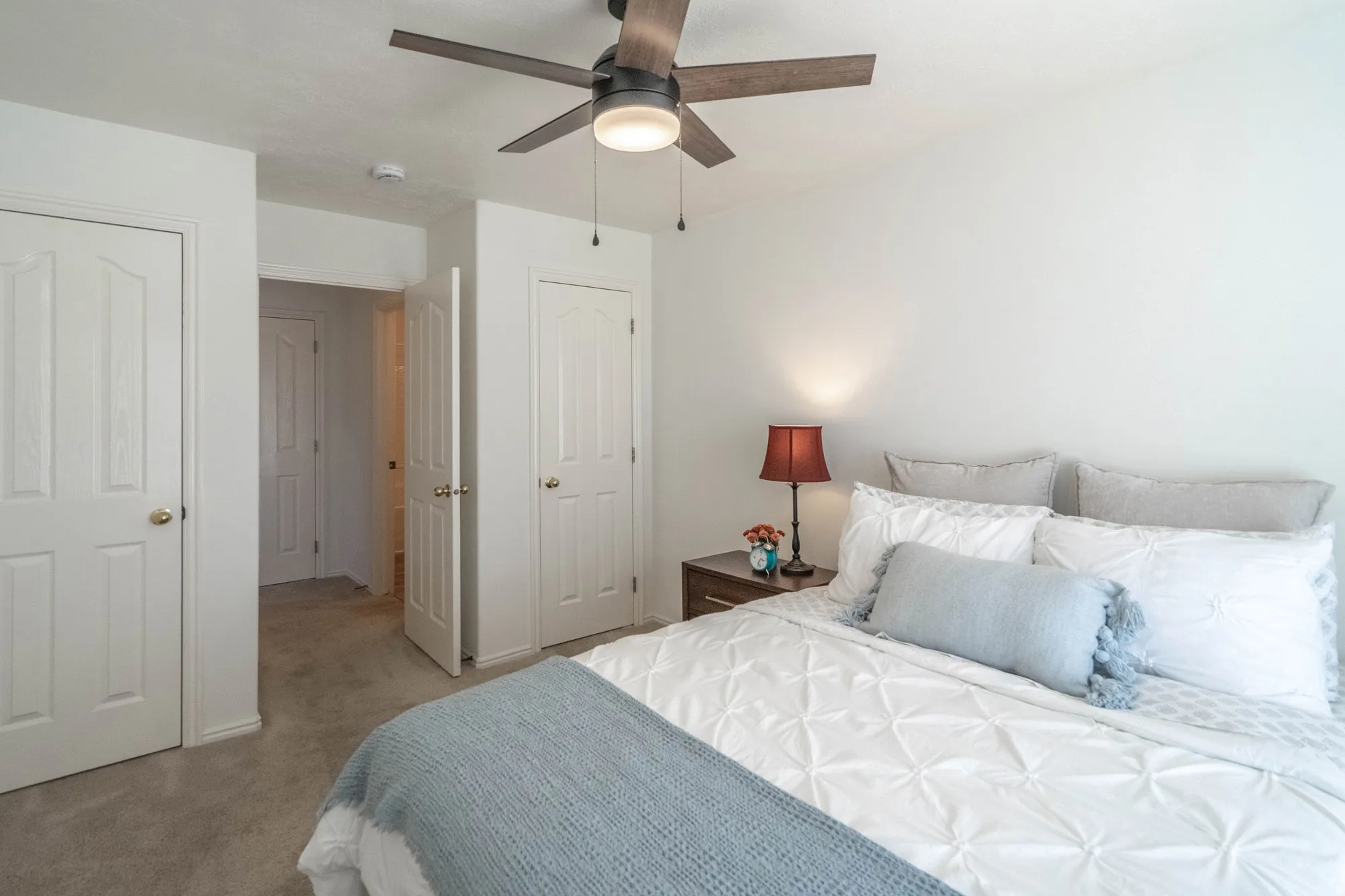 Light-filled interior featuring white walls and neutral carpeting