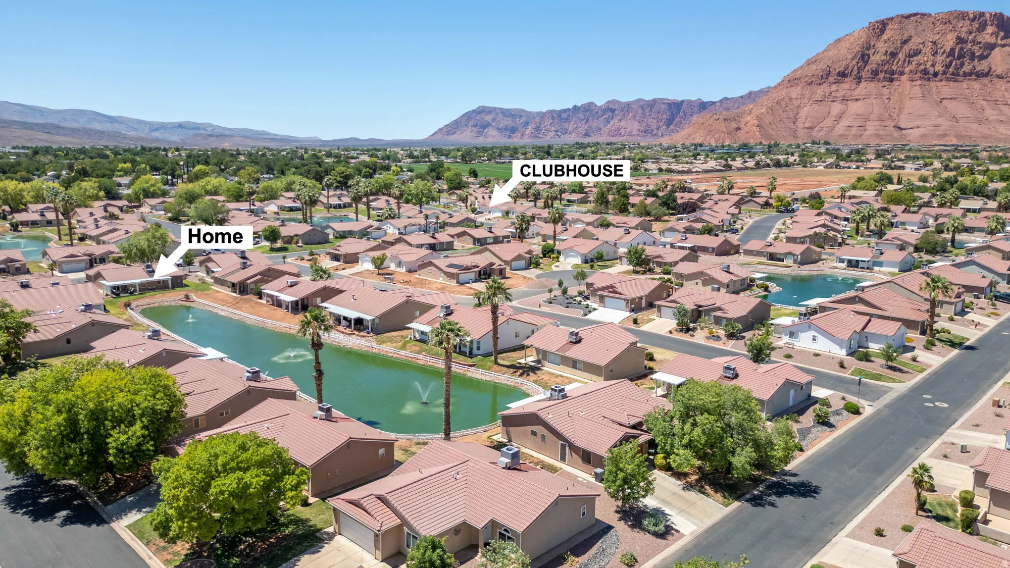 Aerial perspective showcasing a residential community with water features and mature landscaping