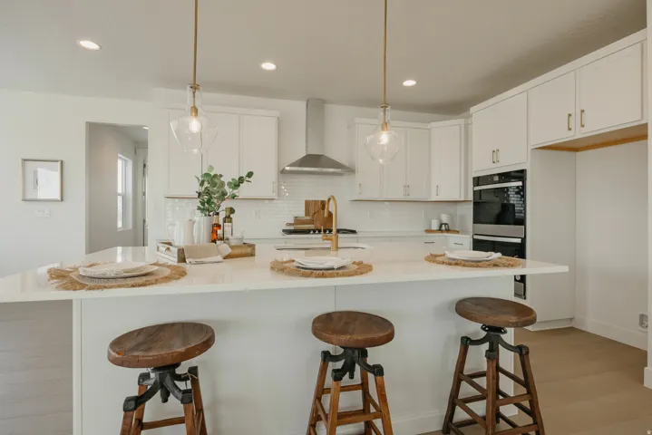 Central kitchen island with a built-in sink and two pendant lights