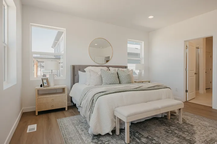 Bedroom featuring wood-finish flooring, recessed lighting, and multiple windows