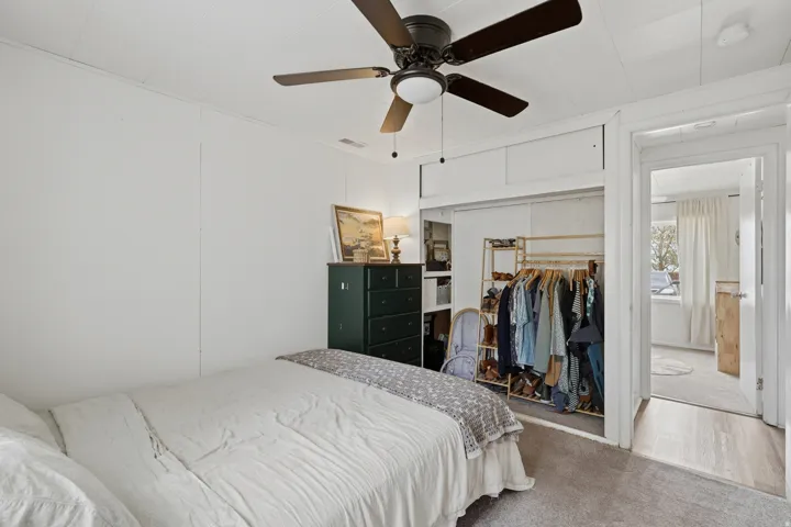 Bedroom featuring a neutral carpet flooring and white paneled walls