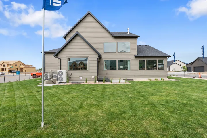 Rear exterior featuring neutral-toned siding and dark trim accents