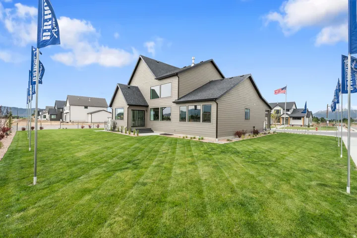 Contemporary-style home featuring light gray siding, dark gray trim, and a dark shingle roof