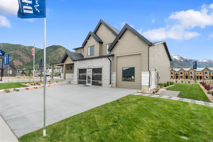 Contemporary multi-story residence featuring light-toned horizontal siding and dark-trimmed gables