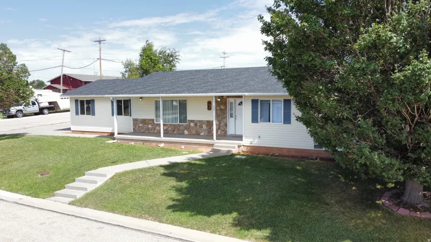 Ranch-style exterior with light-colored siding and a dark shingle roof