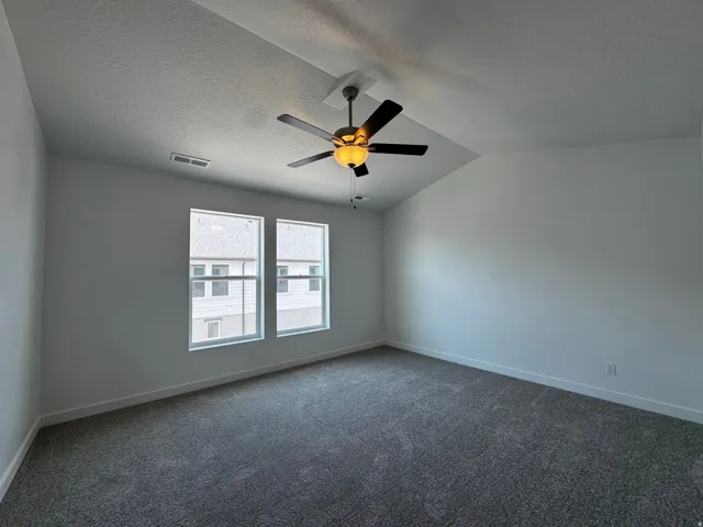 Vaulted ceiling featuring a ceiling fan with integrated lighting