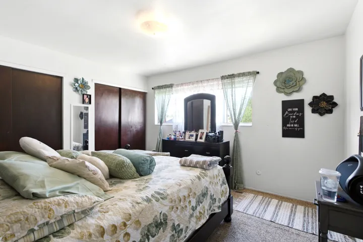 Bedroom featuring light-colored walls and carpet flooring
