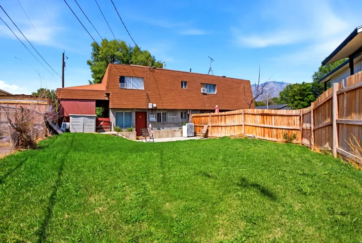 Expansive green lawn with a wood privacy fence