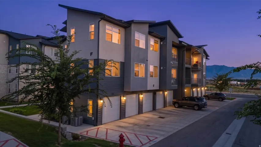 Modern multi-story building featuring a facade with mixed siding and stone accents